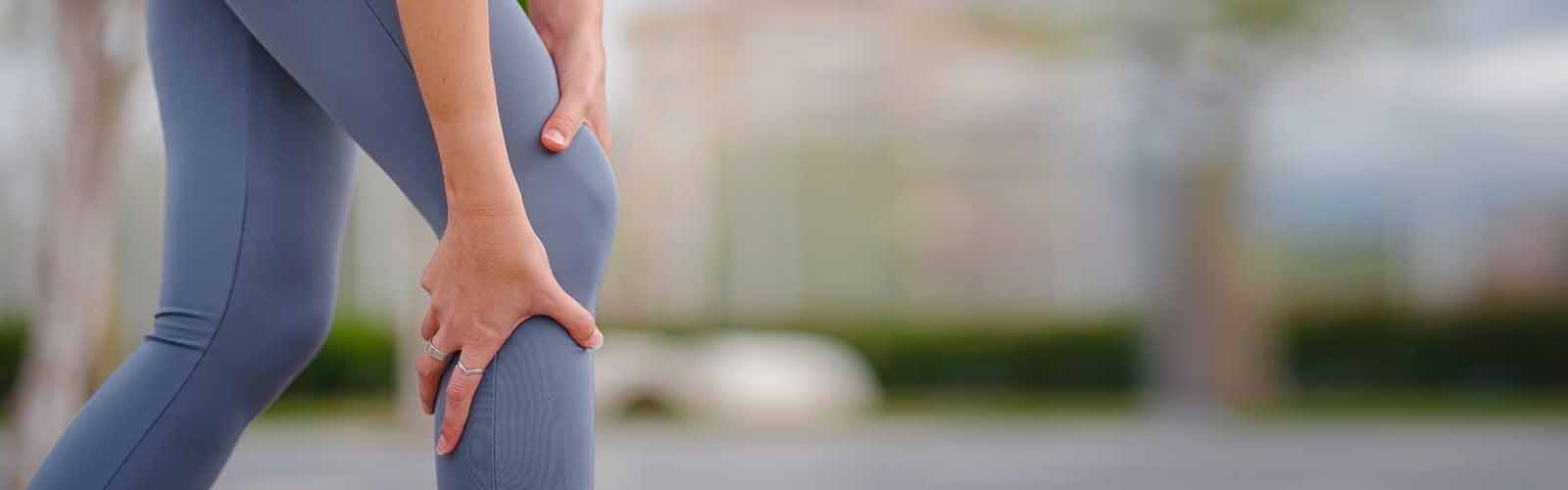 CLoseup of Woman Grabbing Knee in Pain